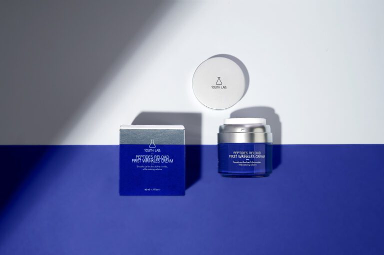 Youth Lab skincare cream with packaging on a blue and white background.